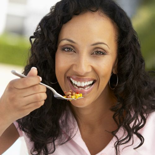 Woman smiling as she eats
