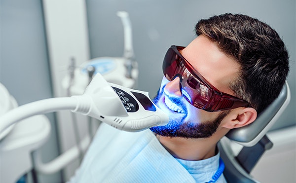 Dental patient receiving tooth whitening treatment